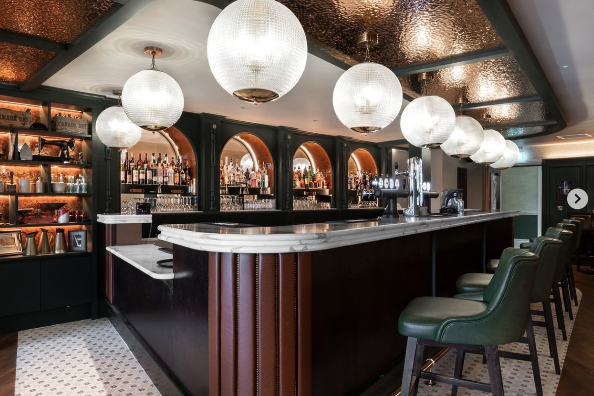 Bar area with copper ceiling and globe lights