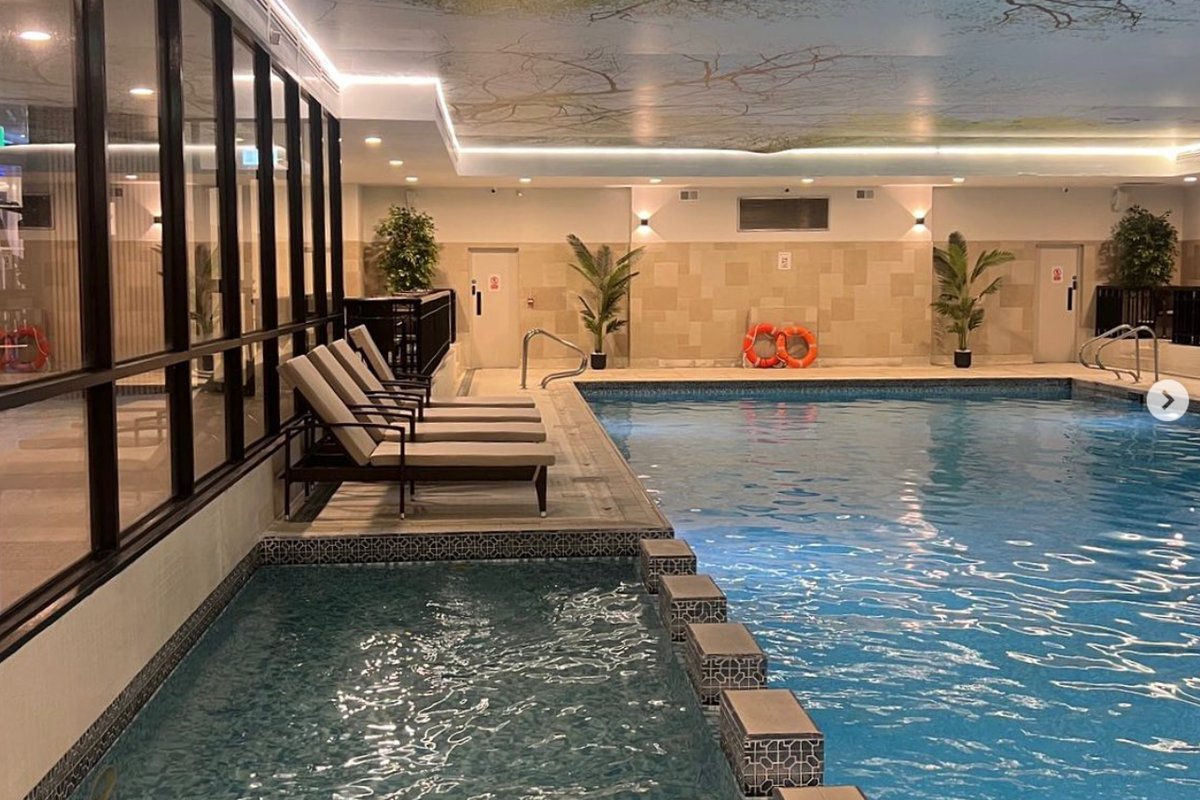 Pool interior with tree ceiling mural